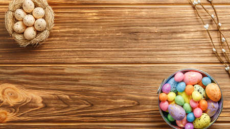 easter composition top view. eggs in the nest on rustic wooden background flat lay with space for...