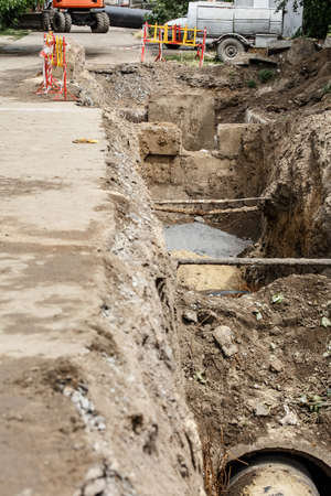 replacement of a sewer pipe deep under the ground, laying pipes under the ground, construction of a...