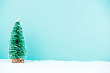 Small toy tree on blue background lot of free space. christmas concept. new year compositionの写真素材