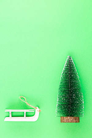 Toy tree on green background. christmas concept. new year compositionの写真素材