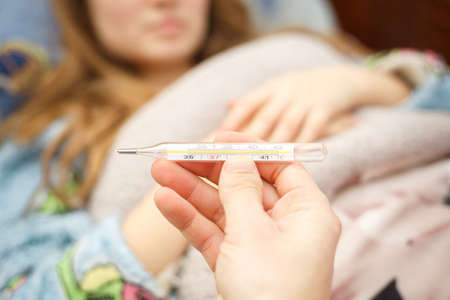 child is measured by the temperature of a thermometer, a cold and the flu is at home with a high...