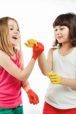 children paint with hands on the table, drawing lesson at school. schoolchildrens hands are painted with paint, a social experiment with paintsの写真素材