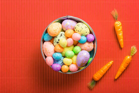 easter composition top view. eggs in the nest on pink coral paper background flat lay with space for text. Congratulatory easter backgroundの写真素材