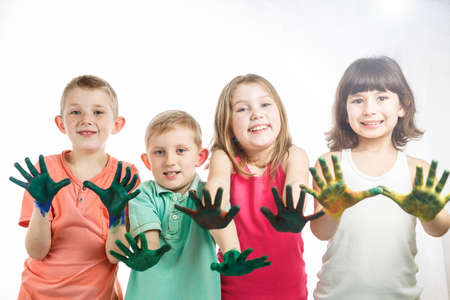 children paint with hands on the table, drawing lesson at schoolの写真素材
