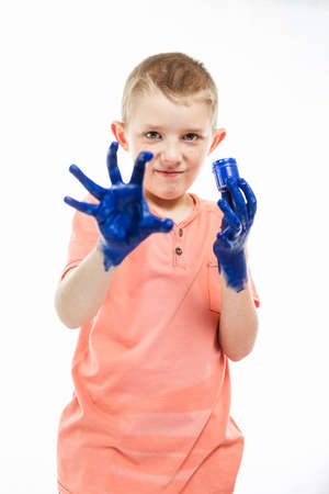boy paint with hands on the table, drawing lesson at schoolの写真素材
