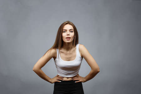 Young beautiful girl posing on gray background in the studio.の写真素材
