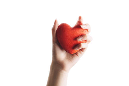 female hand with red heart on palm, isolated on white background. concept of a healthy lifestyle and loveの写真素材