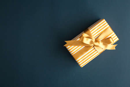 gift on a dark background, top view on a gift box, flat layの写真素材