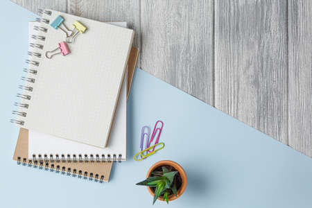 Notebook with a spring on a colored background with paper clips. top viewの写真素材