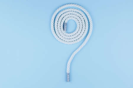 white rope on a blue background, a katana twisted on a tableの写真素材