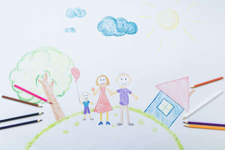 Child's drawing of mom's dad and son on the background of a house, a tree on a sunny dayの写真素材