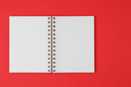 open notebook on red background top view, flat layの写真素材