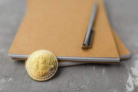 bitcoin on a notebook, coin bitcoin on a table, a lot of free spaceの写真素材