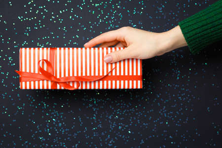 gift on the hands, flat lay on a starry background, holiday greetingsの写真素材