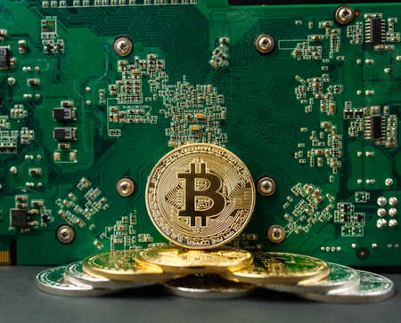 bitcoin on the video card, bitcoin coin on the table near the computer board, a lot of free space