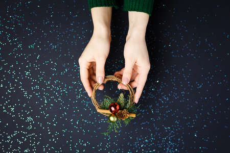 Christmas decorations on the hands, flat lay on a starry background, holiday greetings