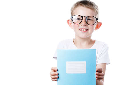 schoolboy holding a notebook in hands isolated on a white background, a boy wearing glasses, a child is getting ready to go to schoolの写真素材