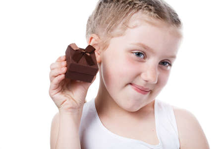 girl with gift in hands isolated on white background. the child receives a gift for St. Valentines Dayの写真素材