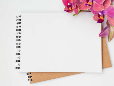 Notebooks with a beautiful flower orchid, congratulations conceptの写真素材
