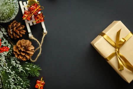 Christmas and New Year background with gifts, deer, stars and fir-trees, flat lay on a dark blue background, holiday greetings, concept of a winter background with free spaceの写真素材