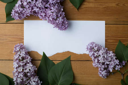 gift with flowers on a wooden background, there is free space for text, a festive flat layerの写真素材