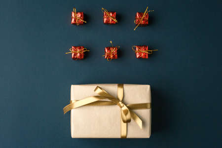 gifts on a dark background lined, top view on a gift box, flat lay