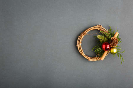 Christmas wreath in the center on a background with a candle and ornaments, Christmas conceptの写真素材