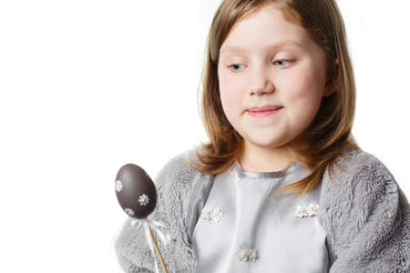 Girl with easter eggs in hands isolated on white background looking at camera and smiling. Concept...