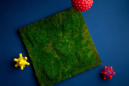 Virus abstract strain model with green Planet Earth on blue background flat lay. Time Pandemic...