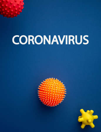 text coronavirus on virus abstract strain model on blue background flat lay. Pandemic Protection Concept. Pathogen organism, infectious micro virology top view.  Vertical photo.の写真素材
