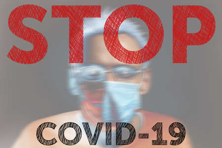 stop covid-19, coronavirus control concept Man in medical mask on gray isolated background. european guy wearing respirator maskの写真素材
