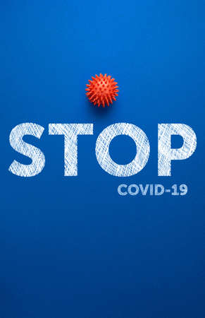 red virus on blue background with text stop covid-19, coronavirus control concept. global world pandemic for fight against virusの写真素材