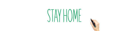marker in hand with the words stay home. concept on the fight against a pandemic virus. The call to...
