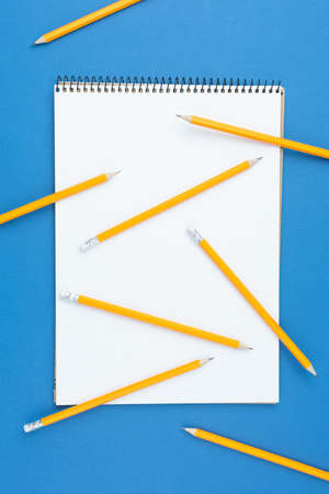 Scrapbook with graphite pencils on a blue background. Concept art. Graphic work planning. Preparing...