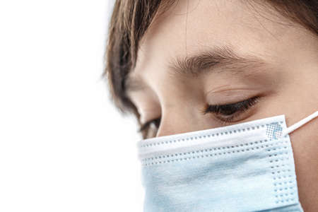 Little girl in a medical mask on white isolated background. Backlight Photo. Healthcare and medical...