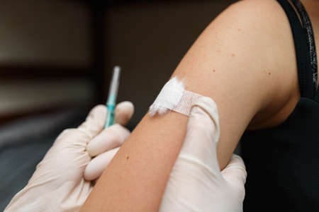 Little girl Vaccinated in the arm. Prevention of children diseases through vaccination. Health care and medicine concept. Focus on shoulder.の写真素材