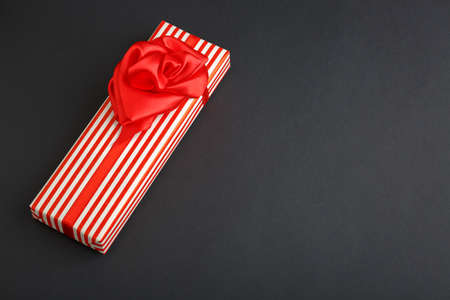gift on a dark background, top view on a gift box, flat lay