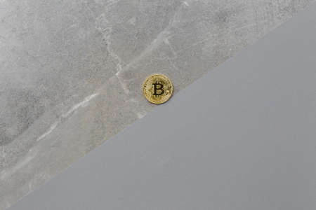 Bitcoin coin roll up on gray marble background, top view. Bitcoin growth in market visualized, concept for cryptocurrency market, flat lay.の写真素材