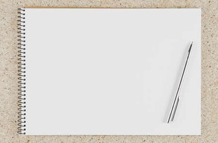 open school notebook with pen on the table top view, spiral notepad with blank page. flat lay of...