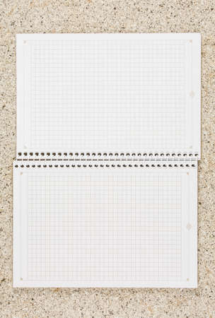 open school notebook vertical on the table top view, spiral notepad with blank page. flat lay of...