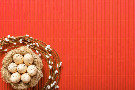 easter composition top view. eggs in the nest on pink coral paper background flat lay with space for...