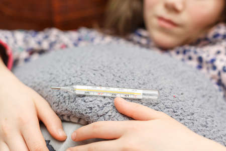 child is measured by the temperature of a thermometer, a cold and the flu is at home with a high...