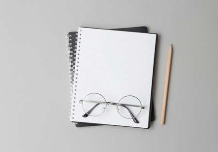 top view of a open black notebook with pencil on a gray background, school notebooks with a spiral spring, office notepad flat layの写真素材