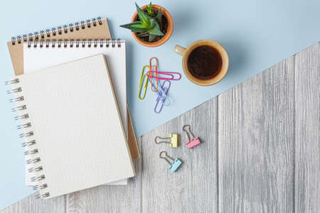 Notebook with a spring on a colored background with paper clips. top view