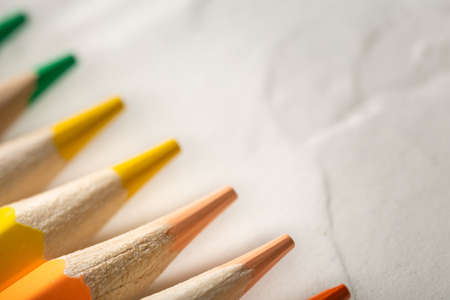 colored pencils on a white background close-up in macro photography. art set of pencils with free space.の写真素材