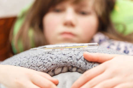 child is measured by the temperature of a thermometer, a cold and the flu is at home with a high...