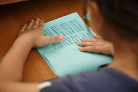 child learns the multiplication table at a desk, homework, a lesson in mathematics. independent...