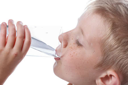 little boy drinks clean water from glass, adherence to balance of fluidity in body, photo isolated...