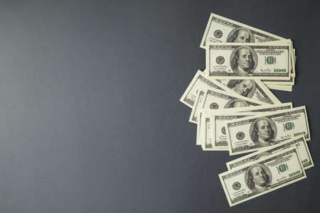 Hundred money bills on gray isolated background top view horizontal photo this.の写真素材