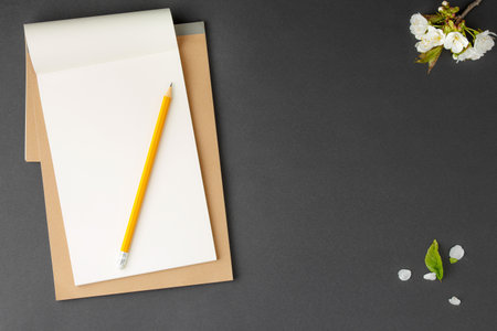 Brown notebook with yellow pencil pen.